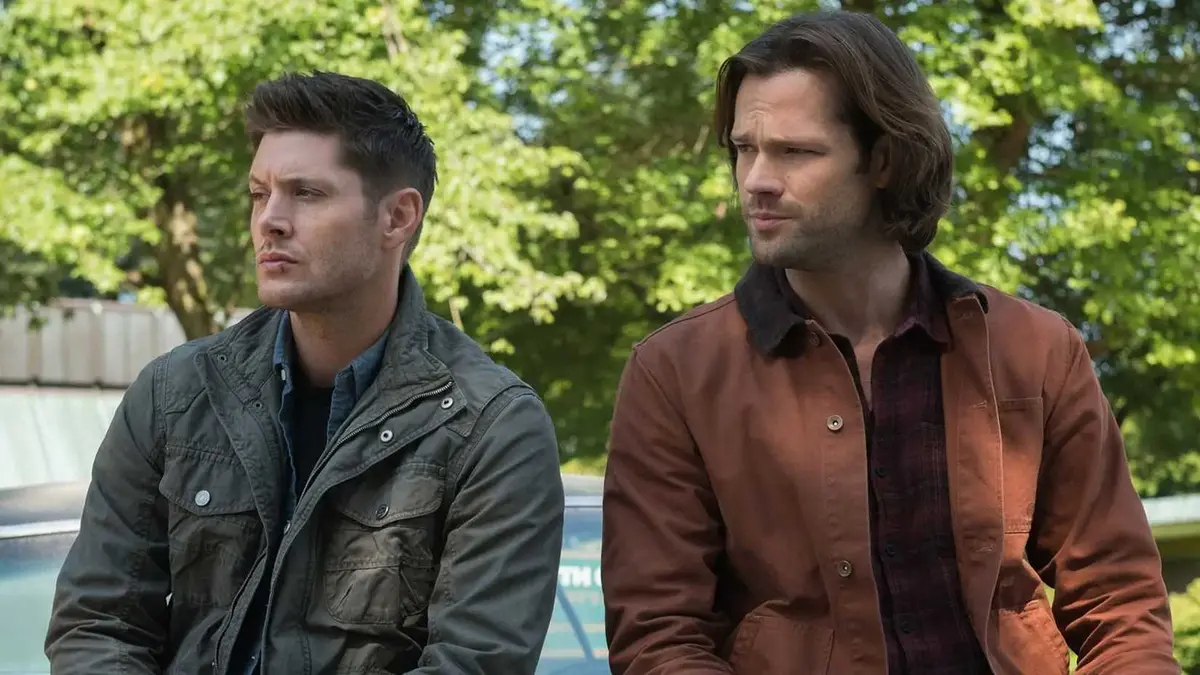 Supernatural's Sam And Dean leaning on a car