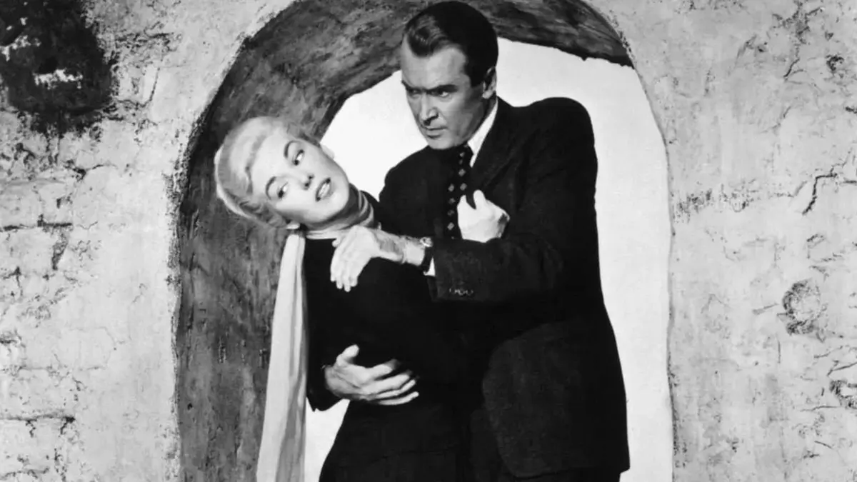 James Stewart as John Scottie Ferguson holding onto Kim Novak as Judy Barton in Vertigo