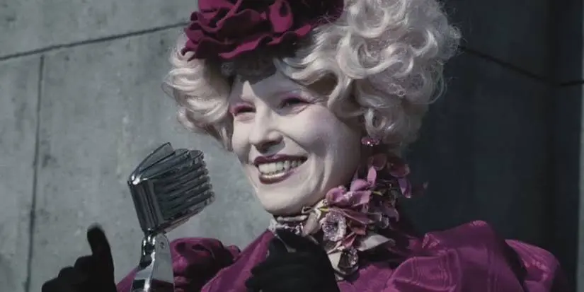 Effie talking into a microphone during the reaping from The Hunger Games
