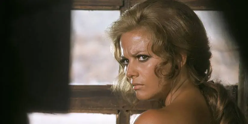 Jill looks over her shoulder at a man in Once Upon a Time in the West