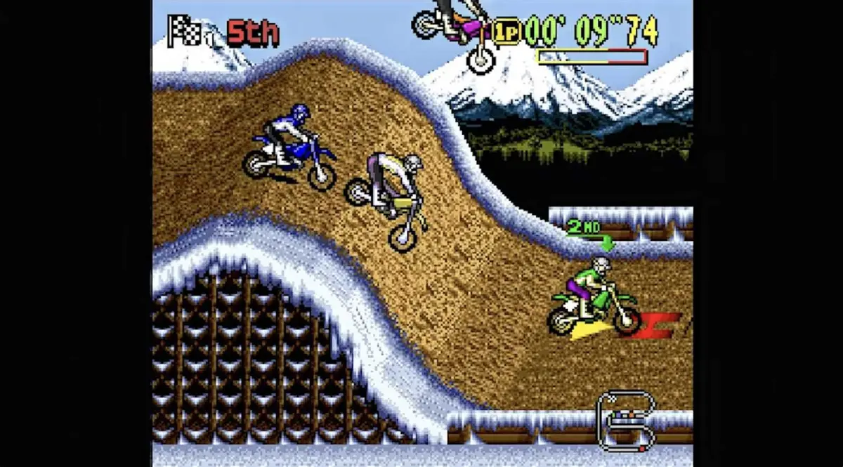 Side-scrolling motocross racing game showing racers going over a hill.