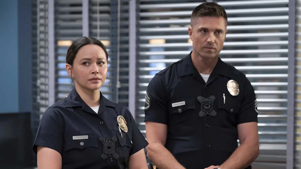 Chen and Bradford in uniform standing together in a still from The Rookie season 7