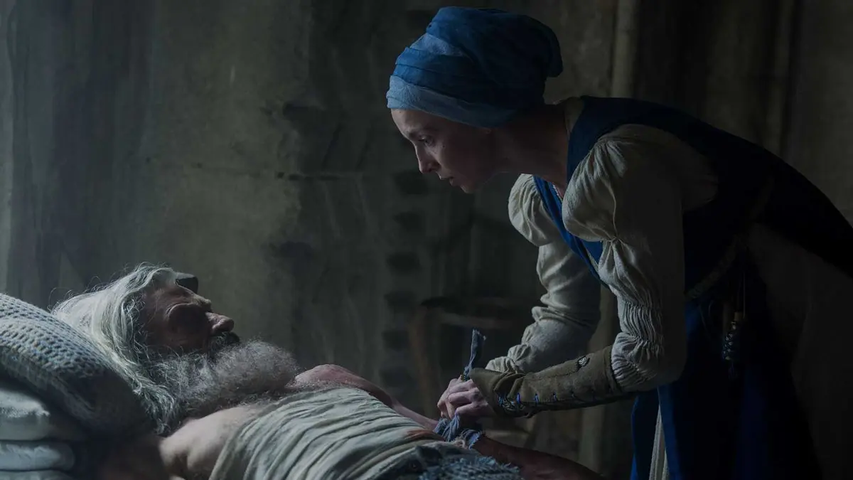 Jodie Comer's Sister Brigid tending to Hugh Jackman's Robin while in bed in The Death of Robin Hood