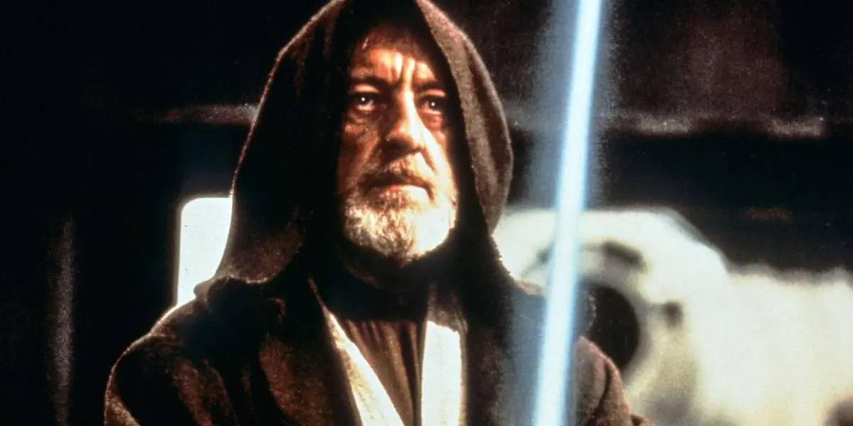 Hooded Obi-Wan wielding a lightsaber in Star Wars A New Hope.