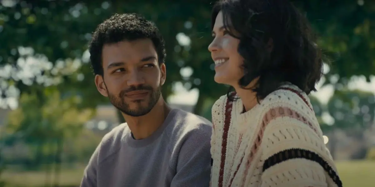 Aren gazes at Lizzie on a park bench in The American Society of Magical Negroes