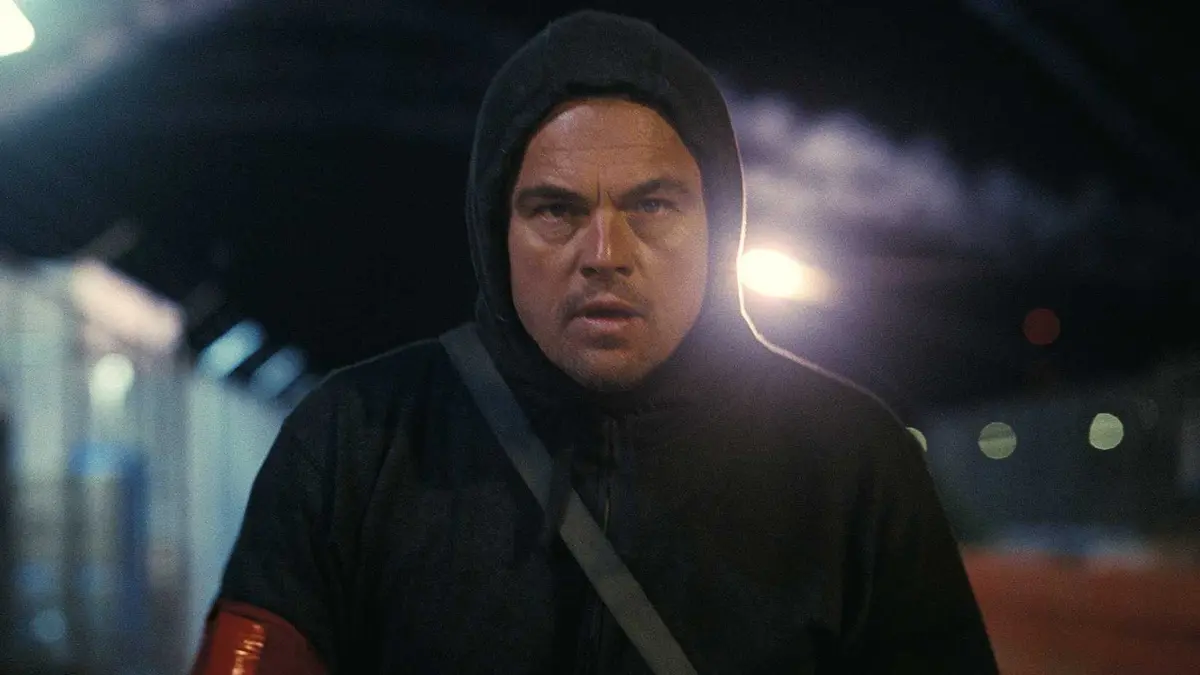 Leonardo DiCaprio running with a hood on from One Battle After Another