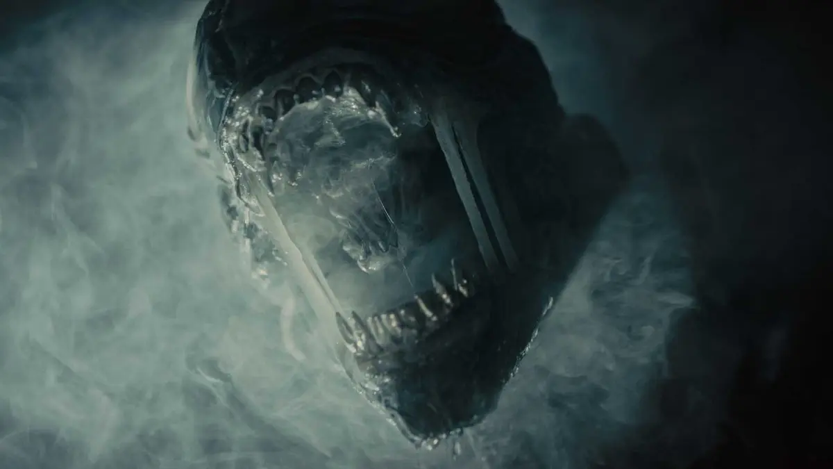A Xenomorph roaring through the smoke in Alien: Romulus.