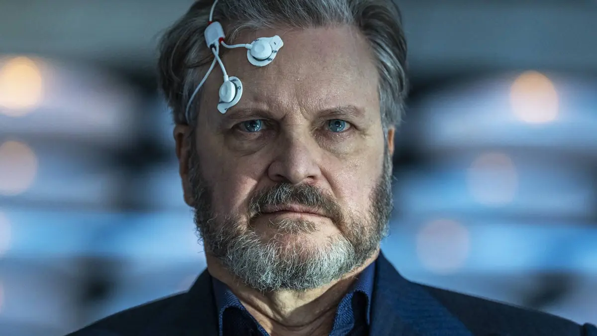 Colin Firth with nodes on his head in Disclosure Day