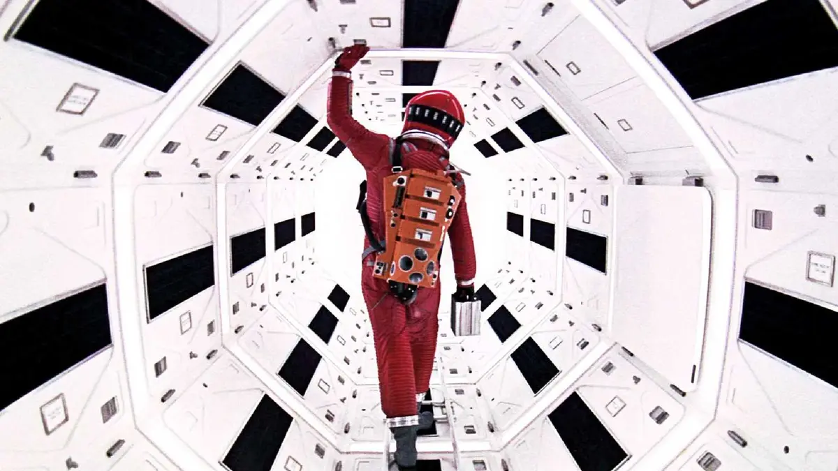An astronaut in a red suit explores a spaceship in 2001 A Space Odyssey