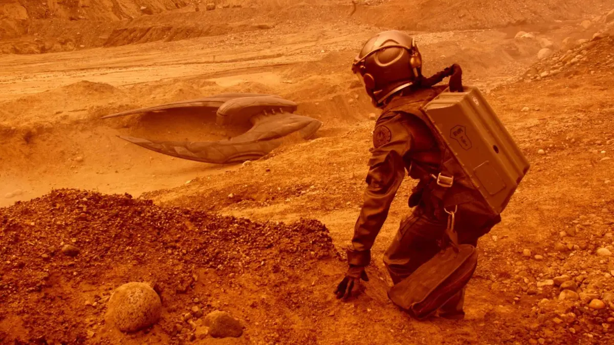 Starbuck looking at a crashed ship in Battlestar Galactica