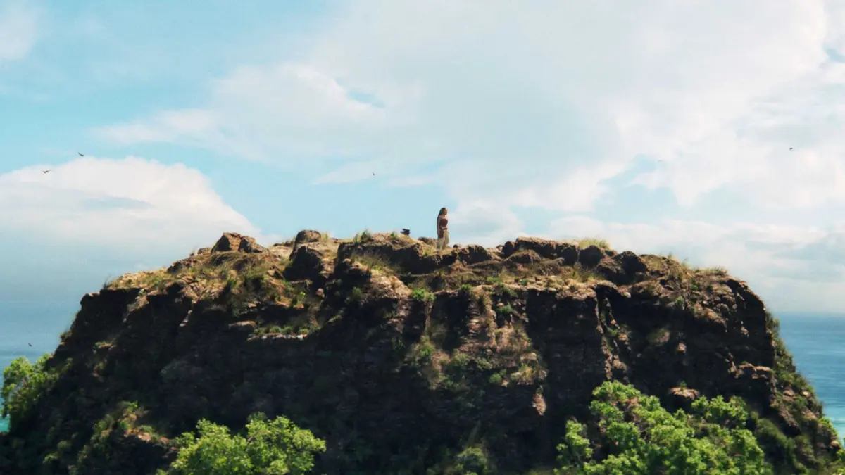 Moana stands atop a mountain in Moana 2026