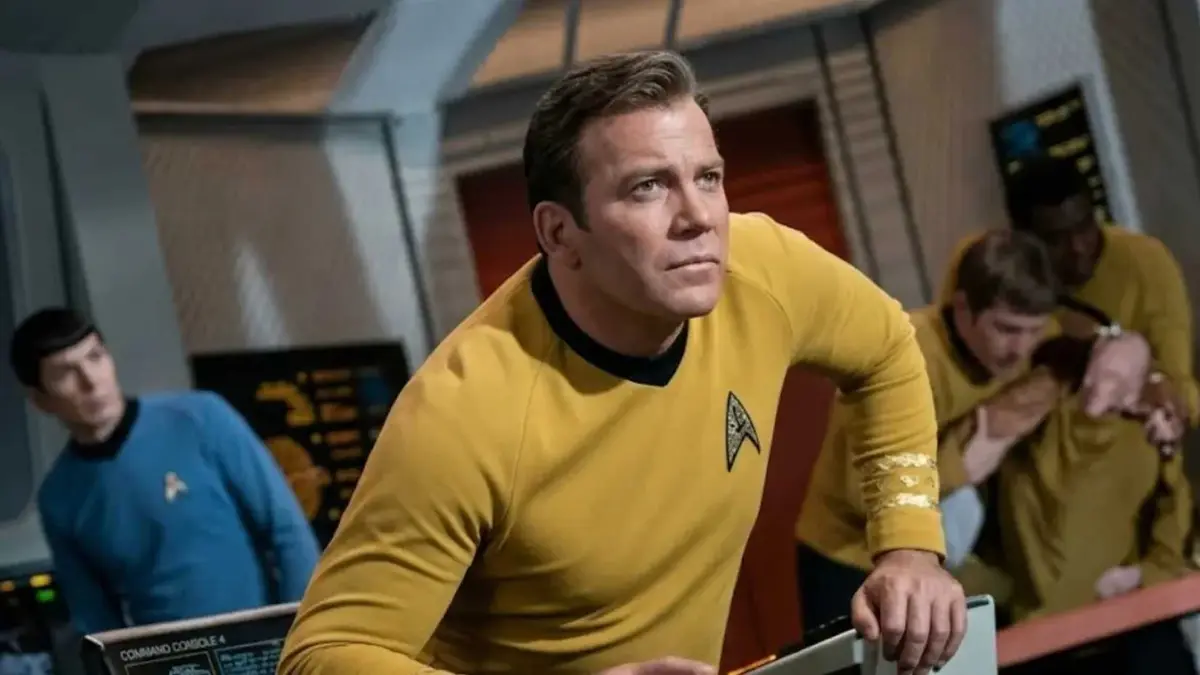 Captain Kirk in Star Trek sitting in his command chair and looking intently