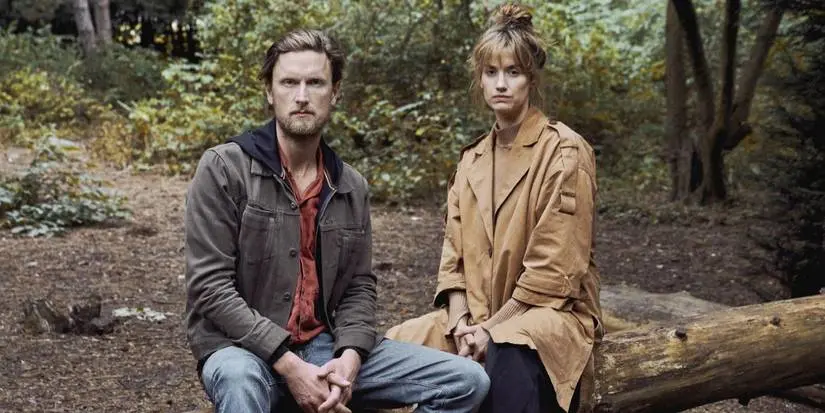 Naia Thulin (Danica Ćurčić) and Mark Hess (Mikkel Boe Folsgaard) sit on a log in The Chestnut Man.