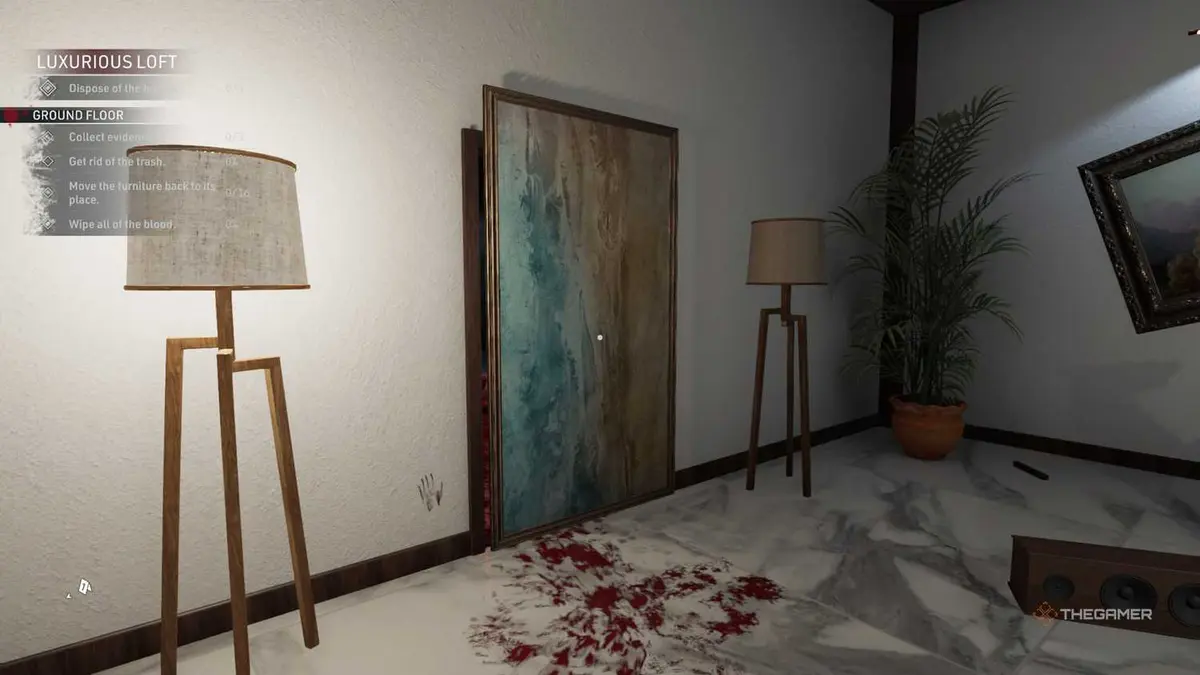 Kovalsky looks at a frame between two lamps in Crime Scene Cleaner