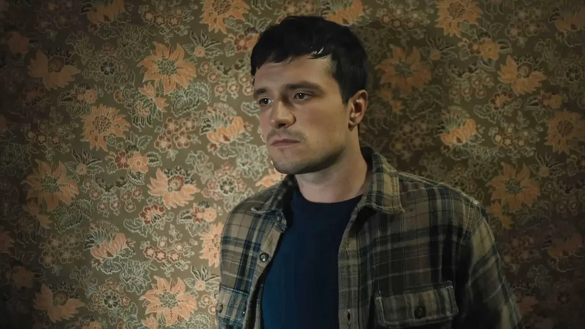 Josh Hutcherson looking bored against floral wallpaper in Five Nights at Freddy's 2