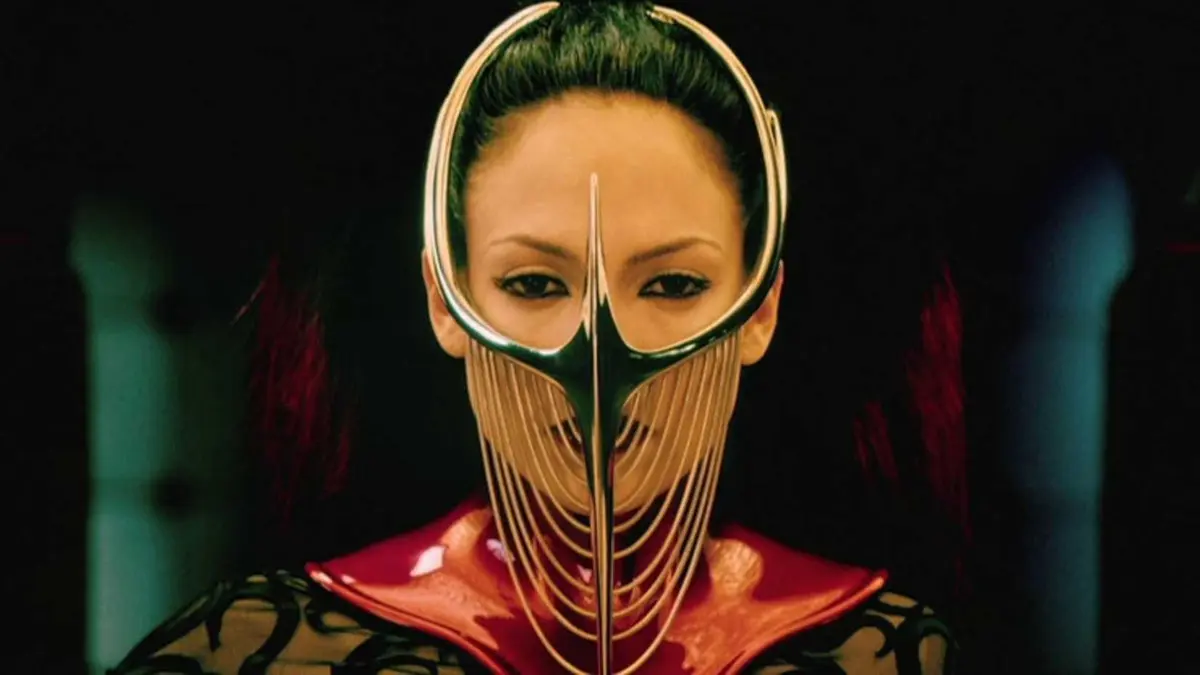 Dr. Catherine Deane in a golden mask looking off-screen in The Cell