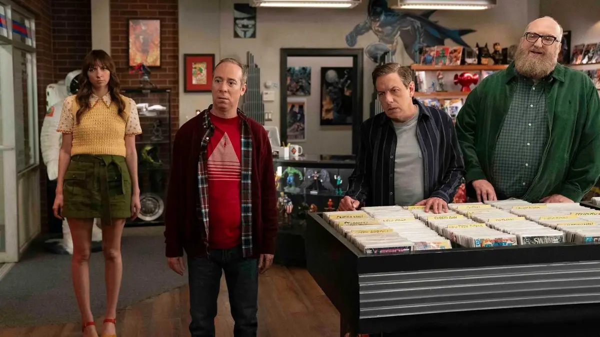 Lauren Lapkus as Denise, Kevin Sussman as Stuart, John Ross Bowie as Barry, and Brian Posehn as Bert standing in a comic book store on Stuart Fails to Save the Universe.