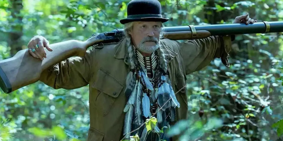 Michael Rooker in Peacemaker Season 2 holding a gun on his shoulders