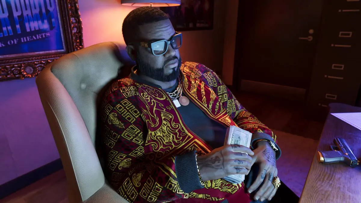 Boobie Ike in Grand Theft Auto 6 sitting in a chair, holding a wad of cash.