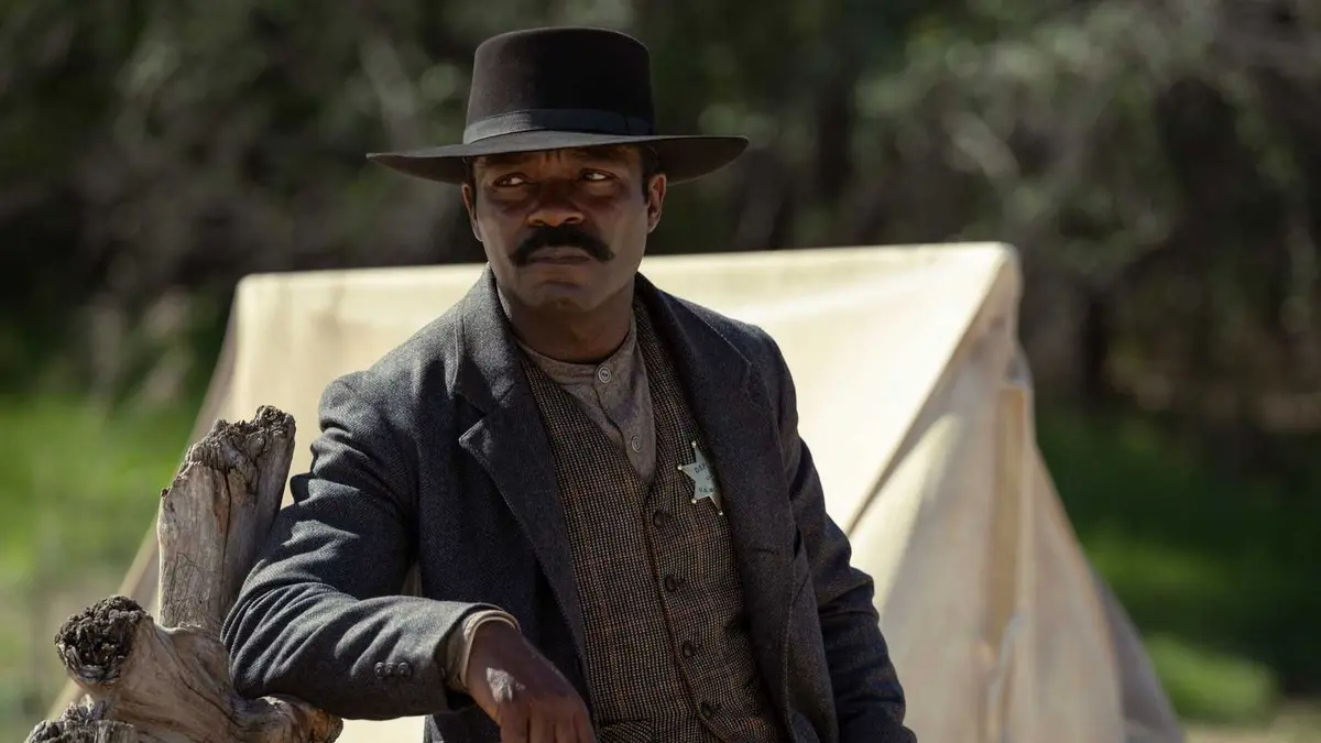 Bass Reeves (David Oyelowo) leaning on a fence in Lawmen: Bass Reeves.