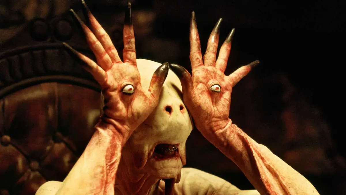 The pale man holds up his hands with eyeballs in his palms in Pan's Labyrinth