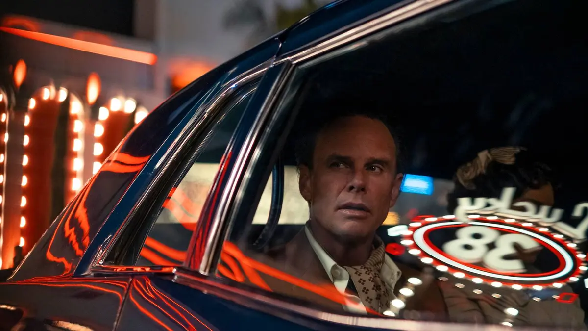 Walter Goggins as Cooper Howard / The Ghoul sits in a car. The reflective window shows the number 38. Image from Prime Video's Fallout season 2.