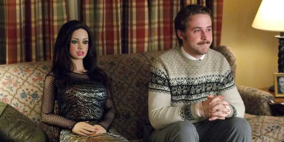 Lars sits nervously on his couch next to a life-sized doll of a woman in Lars and the Real Girl