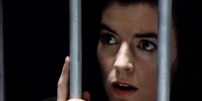 Clarice looking through bars in Comic Strip Persents