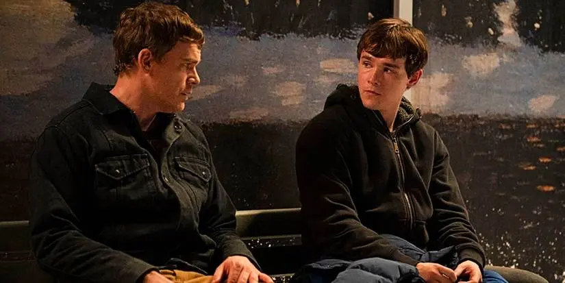 Dexter and Harrison sitting on a bench in Dexter: New Blood