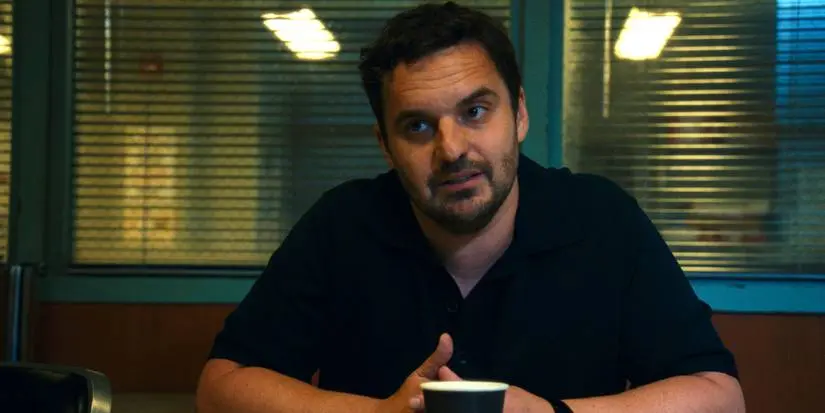 Karl (Jake Johnson) sits in a police interview room in Apple TV+'s Maximum Pleasure Guaranteed