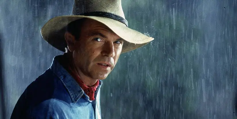 Dr. Alan Grant stands in the rain in Jurassic Park