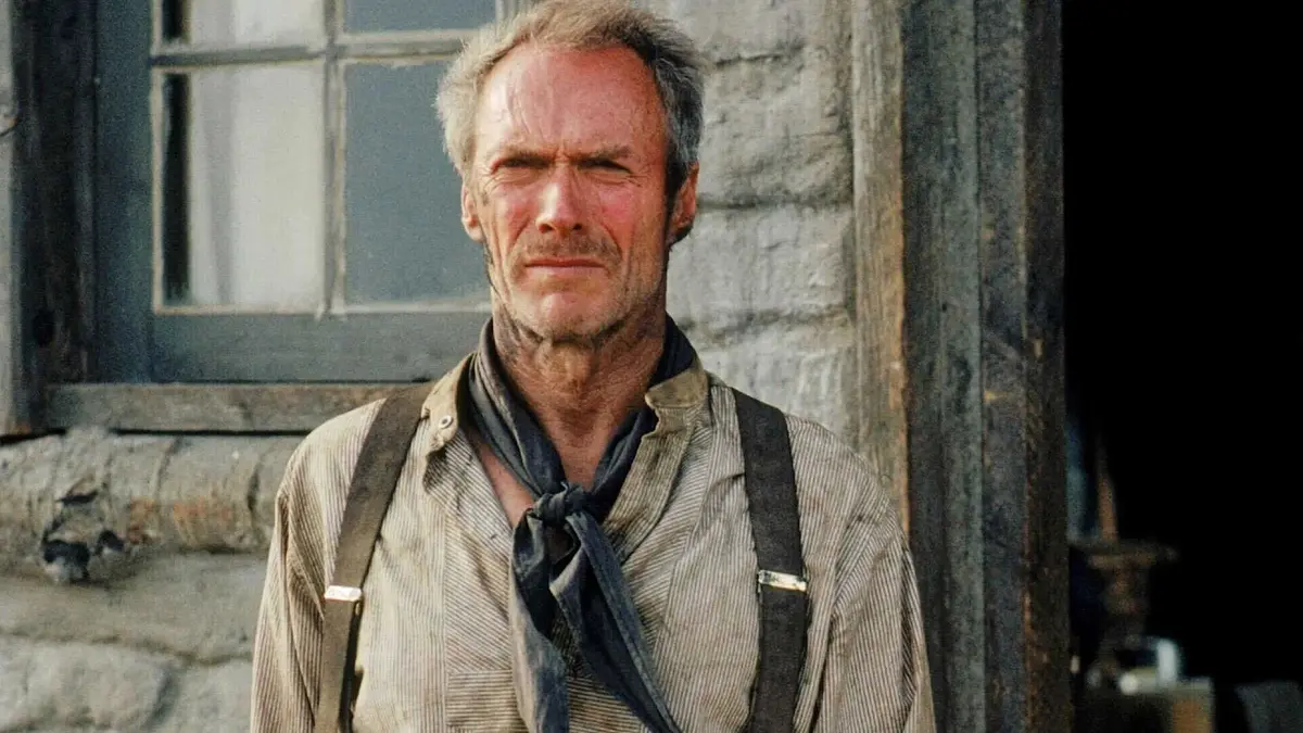 Clint Eastwood stands in front of his home in Unforgiven (1992)