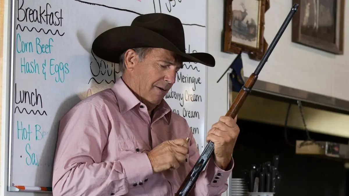 Kevin Costner's John loads a rifle in Yellowstone