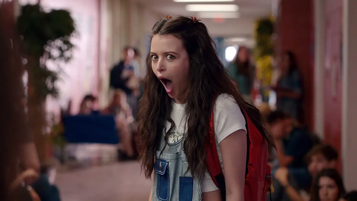 Sara Waisglass as Max looking happy but shocked in the hallways in Ginny and Georgia
