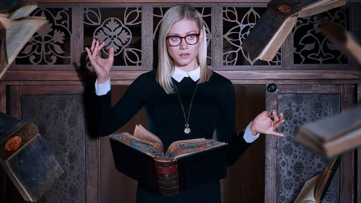 Alice Quinn is surrounded by floating books in The Magicians