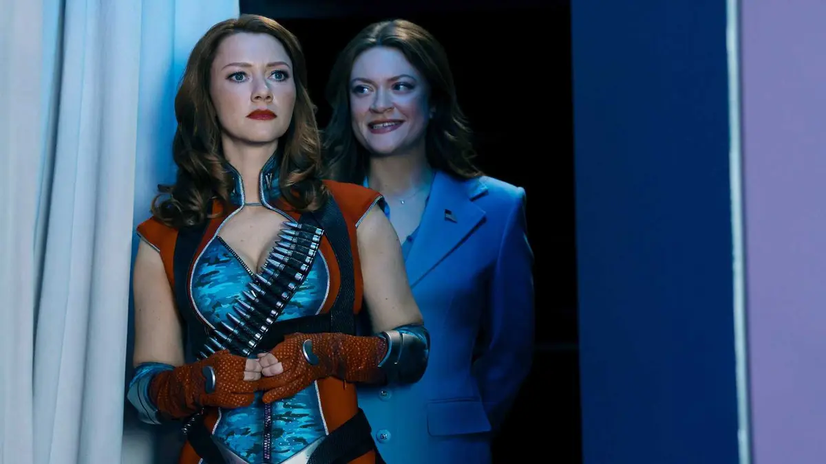 Ashley Barrett (Colby Minifie) with a smile on her face looking at Firecracker (Valorie Curry) in The Boys season 5