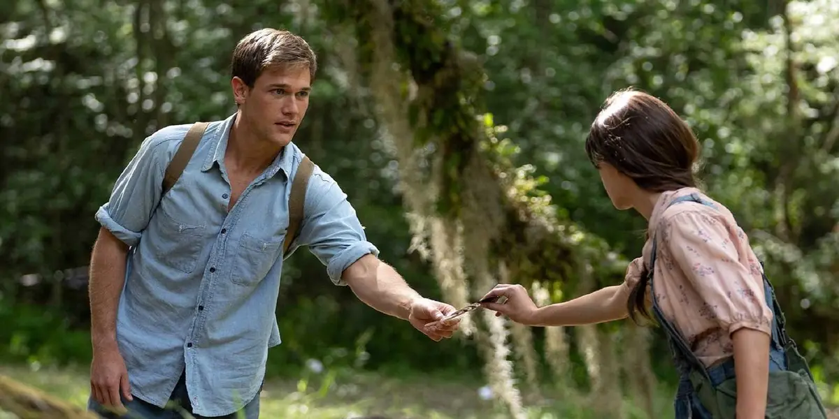 Tate hands something to Kya in Where the Crawdads Sing.
