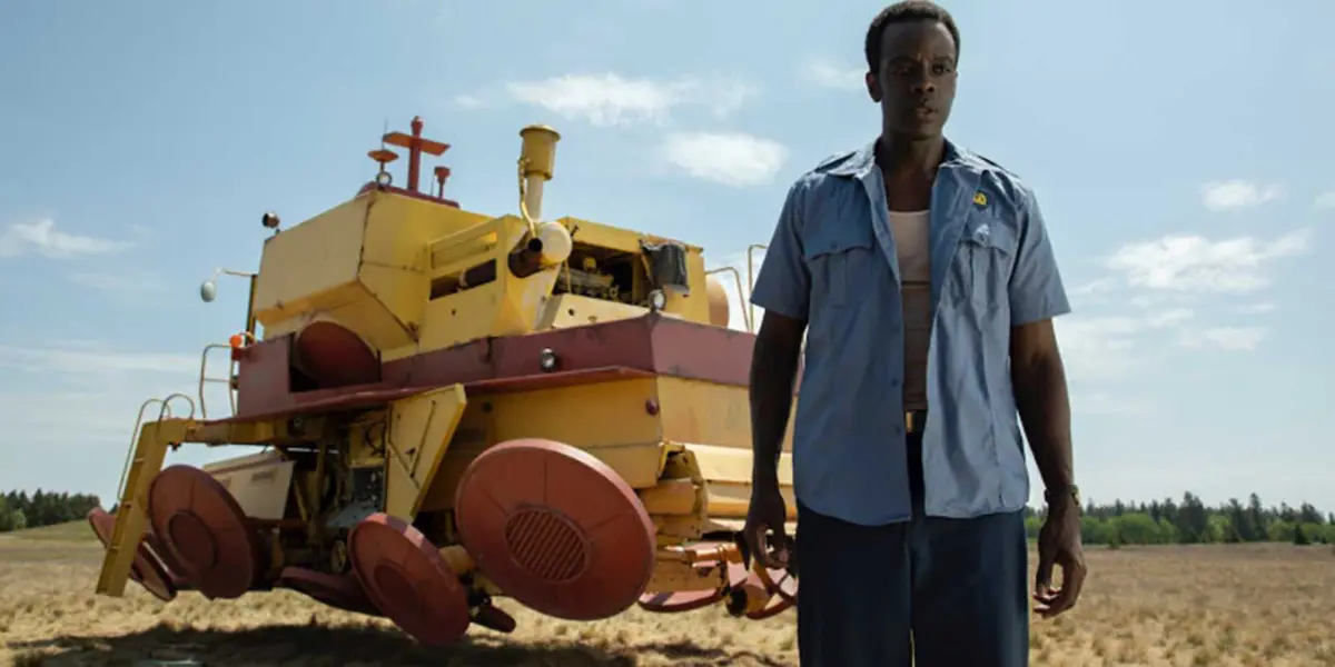 Gaddis standing in front of a floating tractor in Tales From the Loop