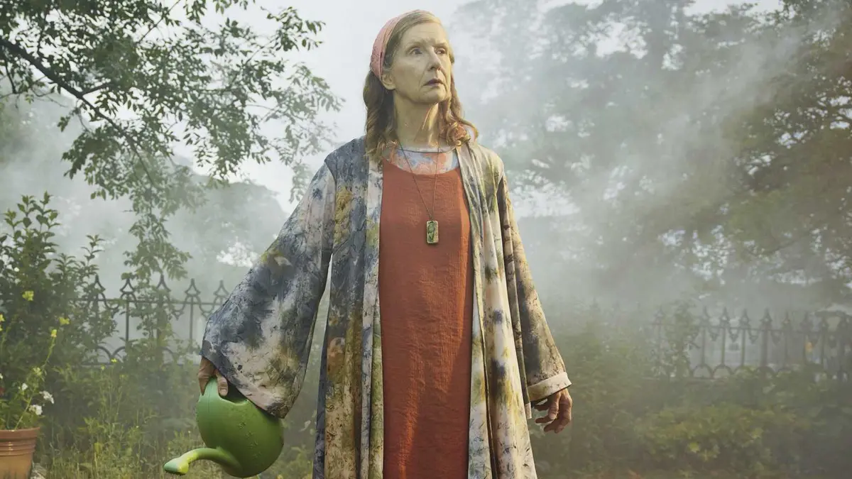 Frances Conroy’s Nathalie watering her plants in The Mist