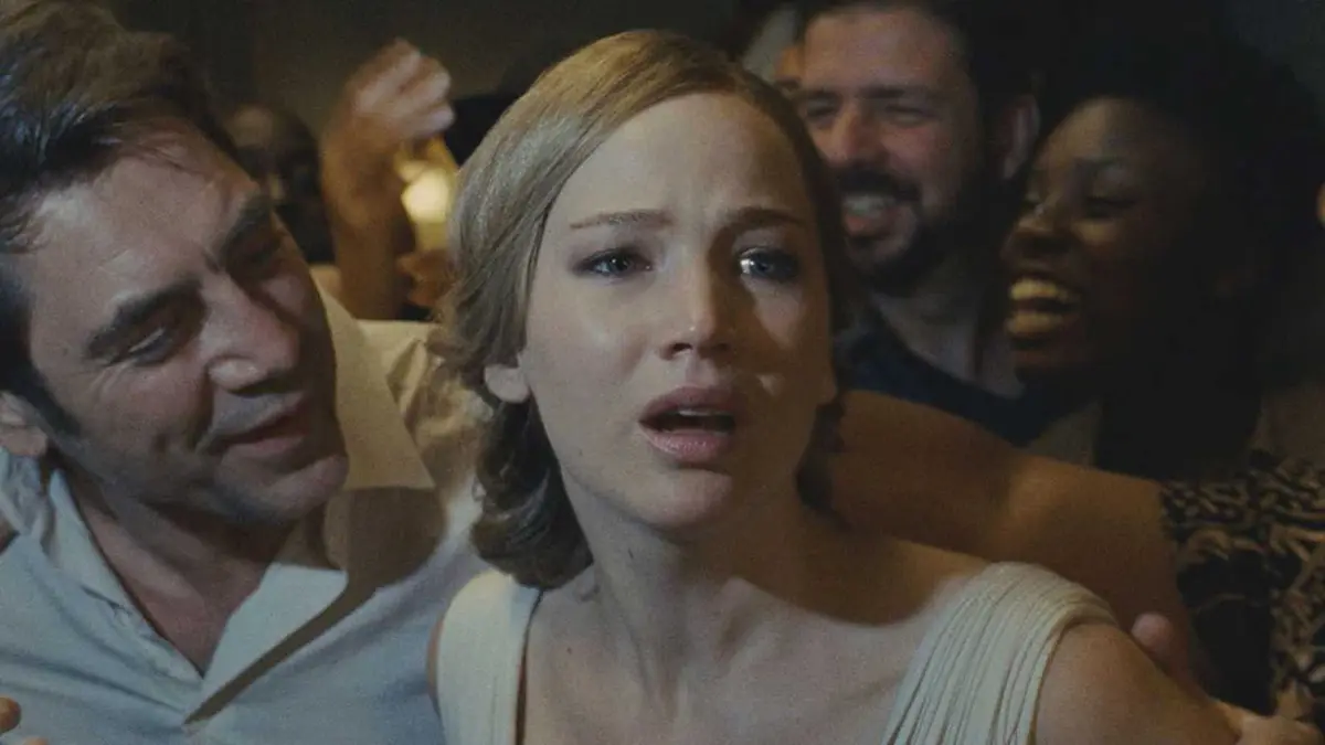 Jennifer Lawrence is being grabbed by several people including Javier Bardem, she looks frightened in the movie Mother