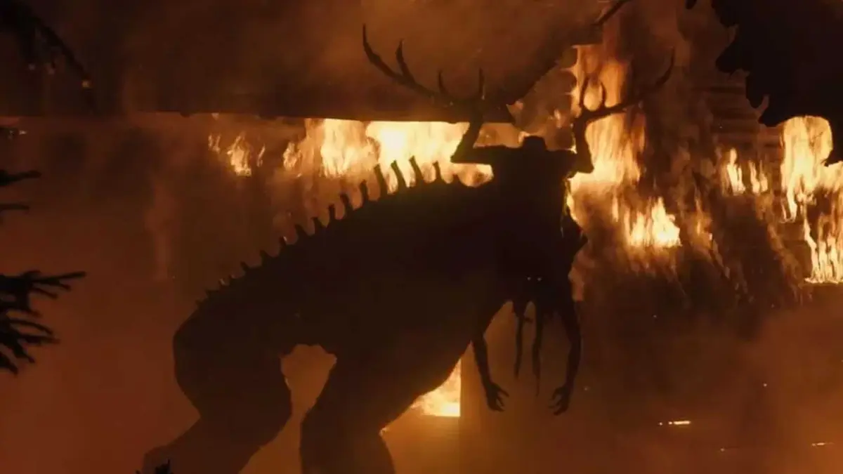 Moder is in front of a building on fire in The Ritual