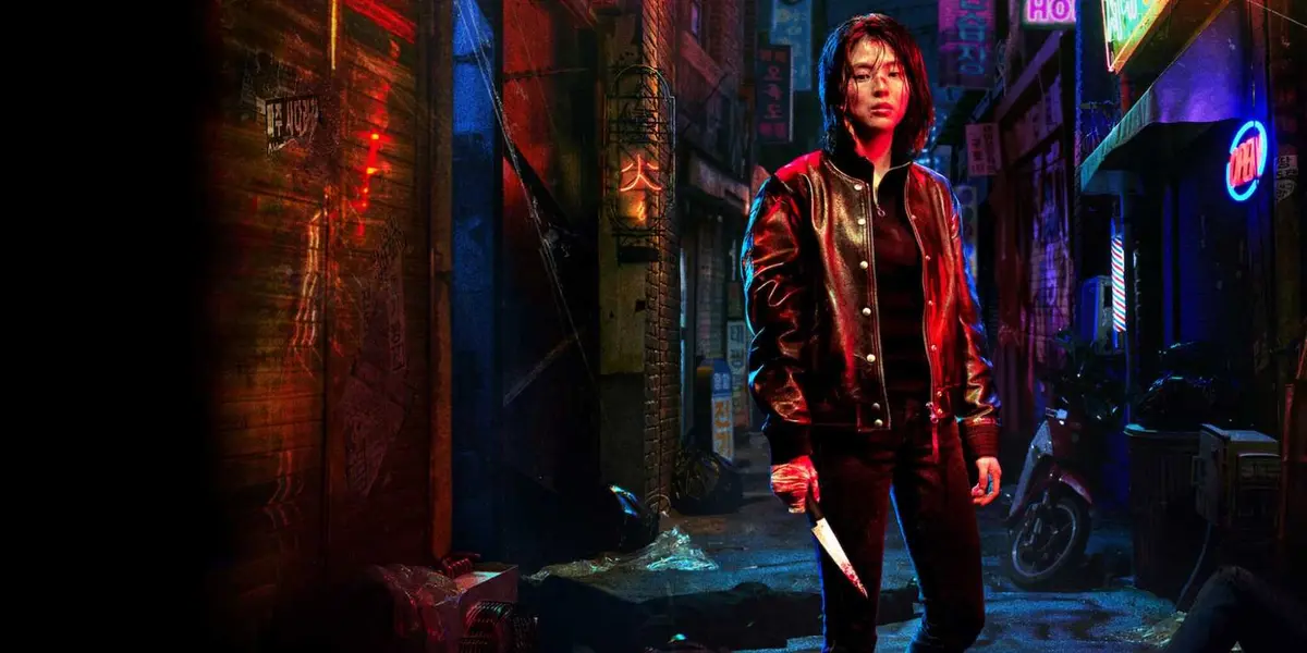 Promotional still of Ji-woo holding a bloody knife in a back alley in Netflix's My Name