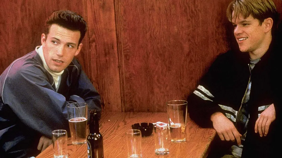 Matt Damon as Will Hunting and Ben Affleck as Chuckie sit together at the bar.