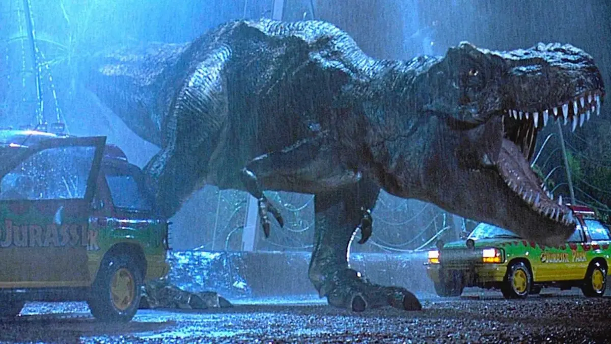 tyrannosaurus escaping its enclosure between two cars in jurassic park