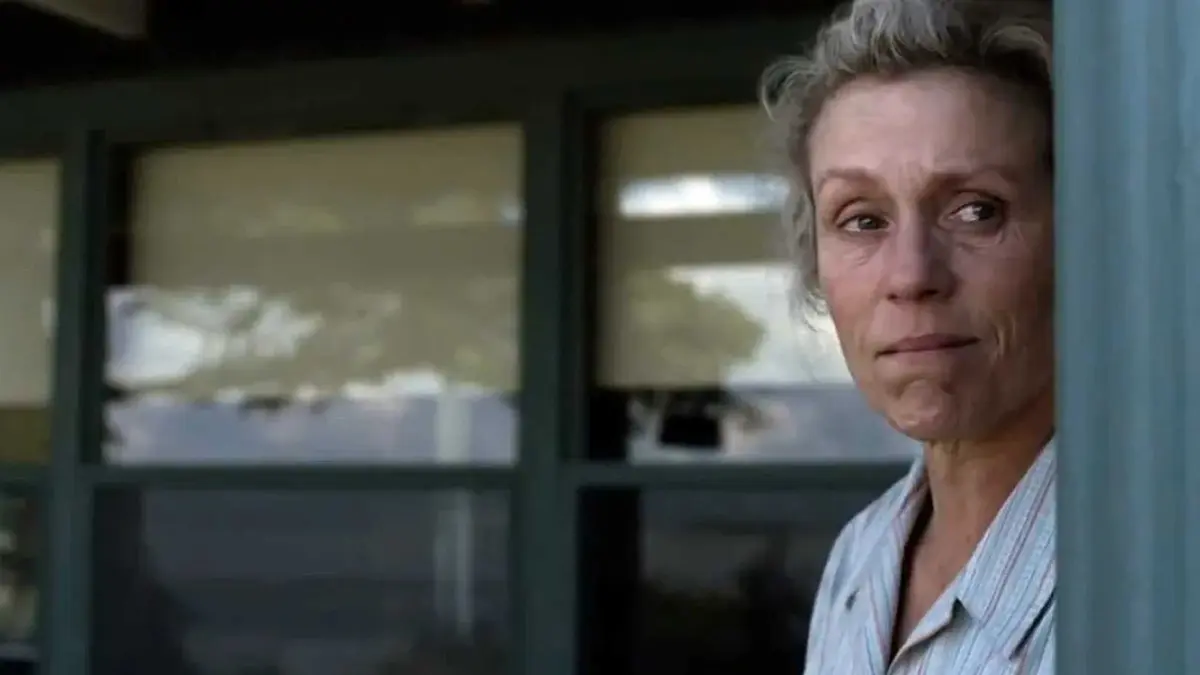 Olive Kitteridge (Frances McDormand) staring out of her house.