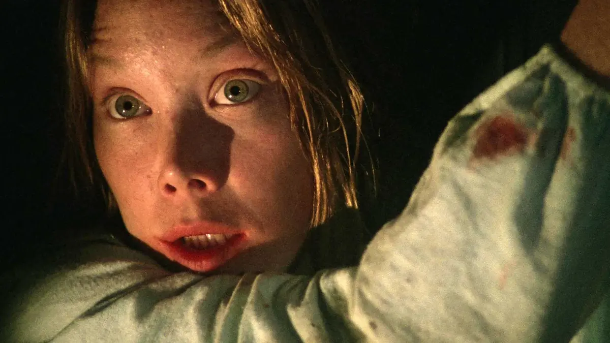 Sissy Spacek's Carrie looking scared while in a tight space in a close-up shot in Carrie
