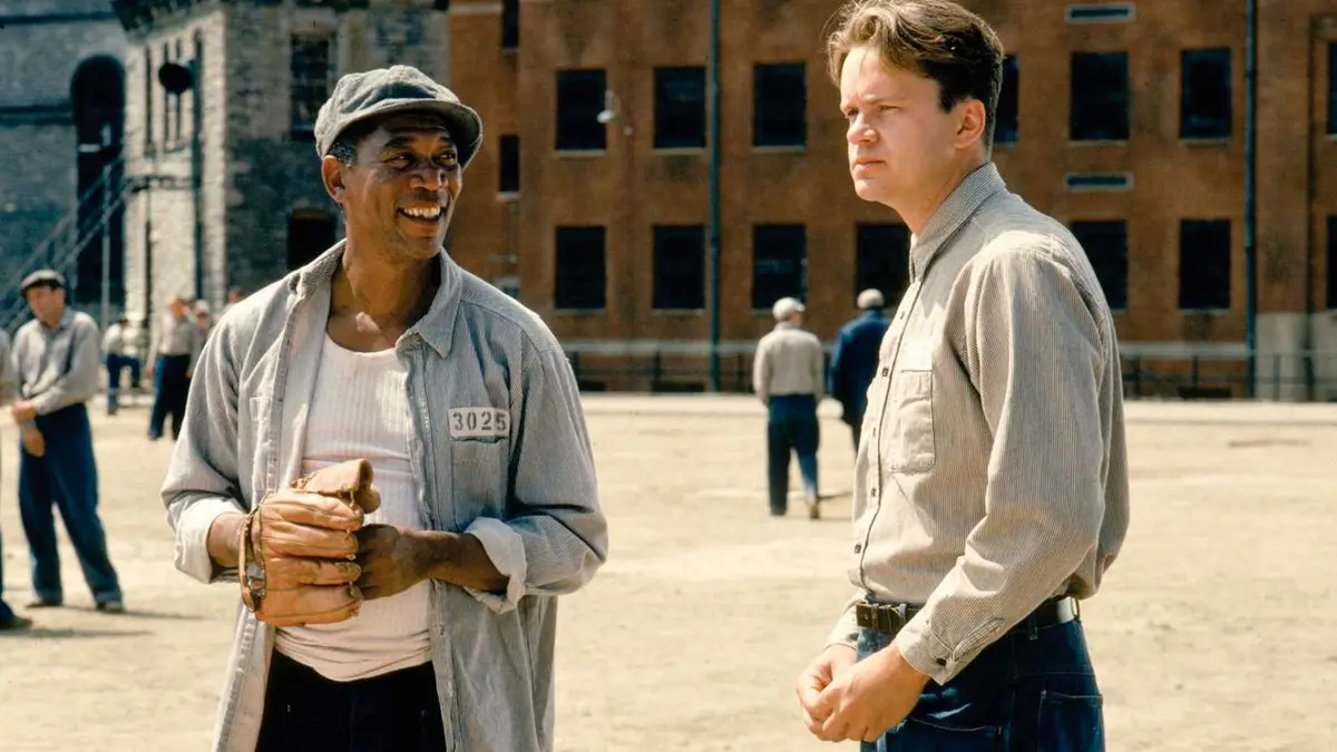 Andy and Red talking in the prison yard as The Shawshank Redemption