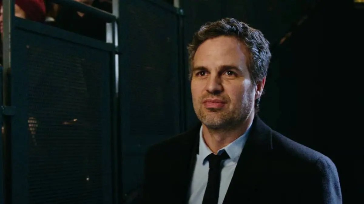 Mark Ruffalo standing beside the bleachers, giving a slight smile, as Dylan Rhodes in Now You See Me 2.