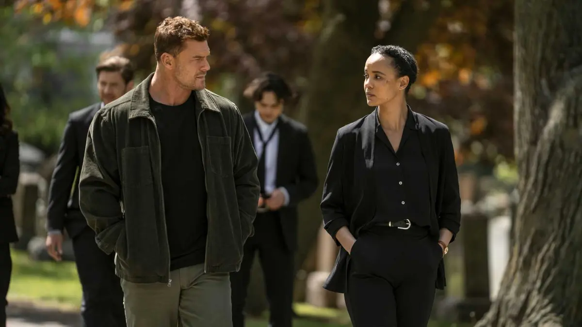 Reacher and Neagley walking through a park and looking at each other