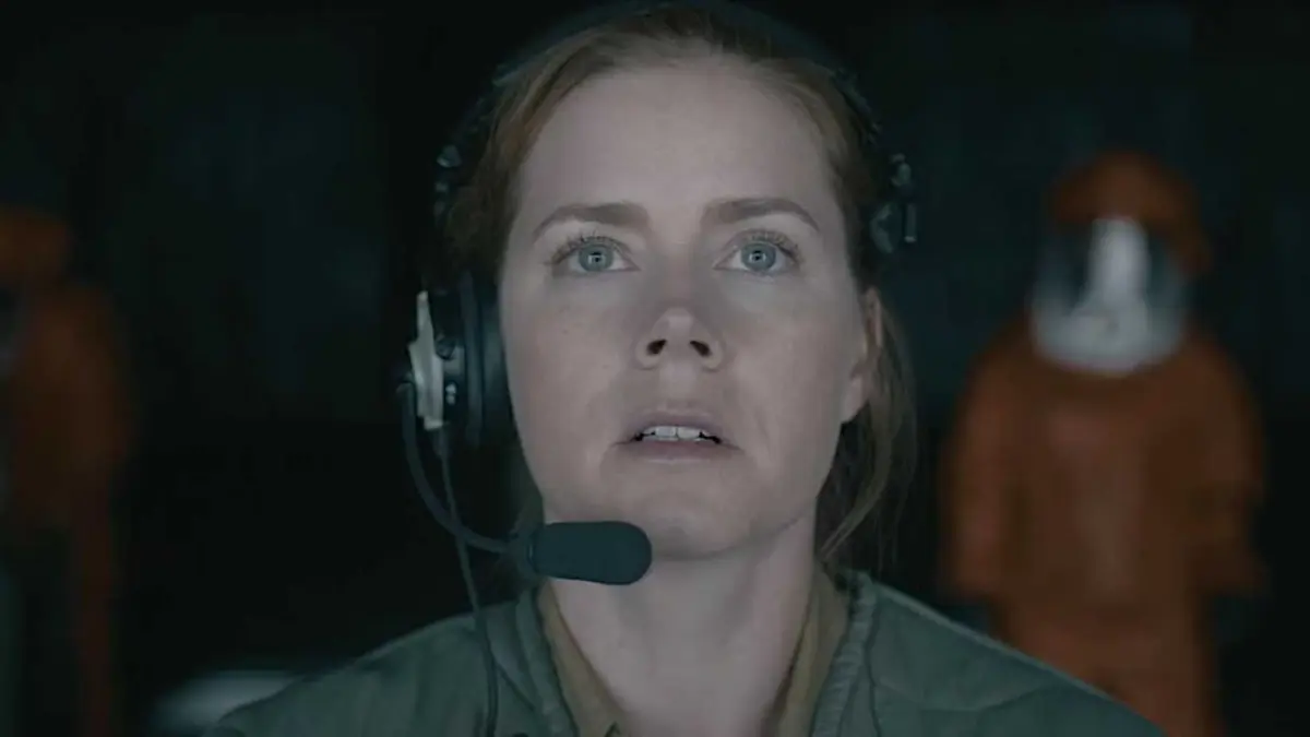 Amy Adams gazes slightly upward with intent focus in a scene from Arrival